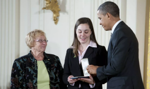 President Barack Obama presents the 2012 Presidential Citizens Medal to Erica Lafferty and Cheryl Lafferty on behalf of Dawn Lafferty Hochsprung at the White House on February 15, 2013 in Washington, DC.