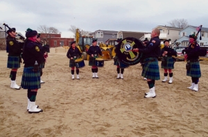 The Breezy Point Catholic Club Pipes and Drums band opened the dedication ceremony with “Amazing Grace.”